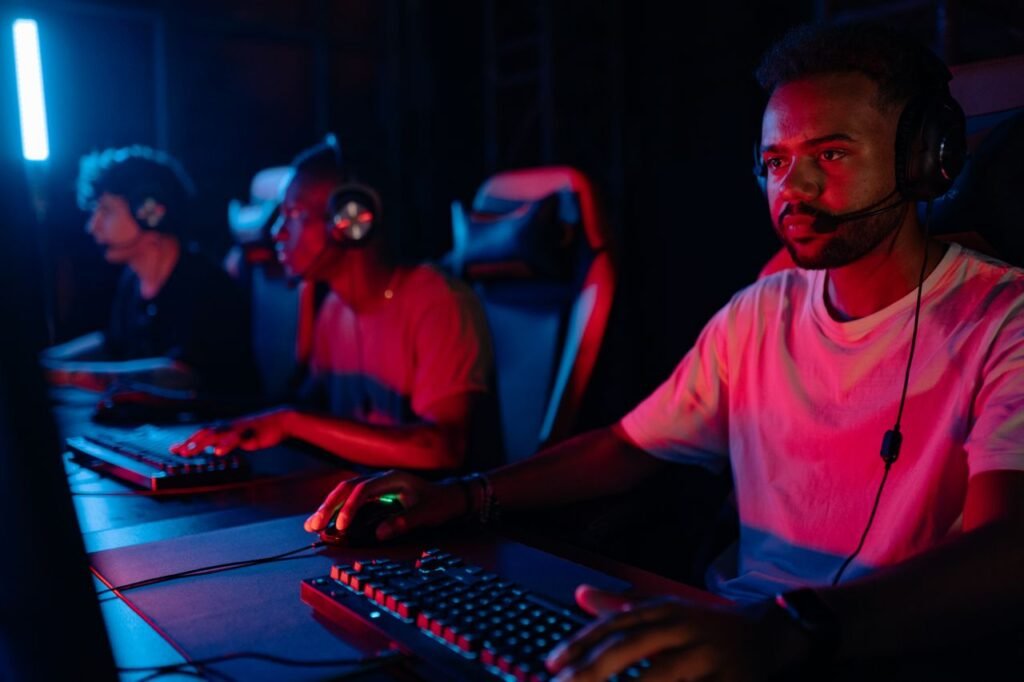 Young men engrossed in a competitive eSports gaming session, displaying teamwork and focus.
